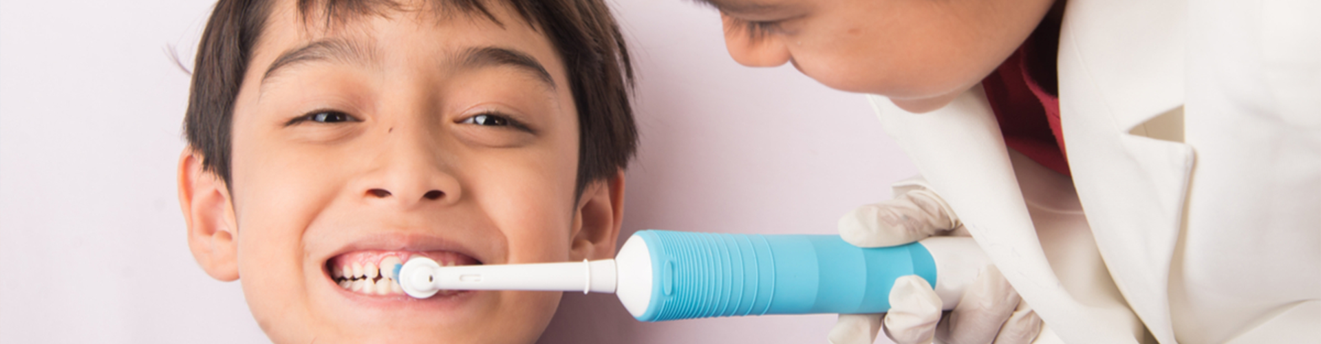 child brushing another childs teeth