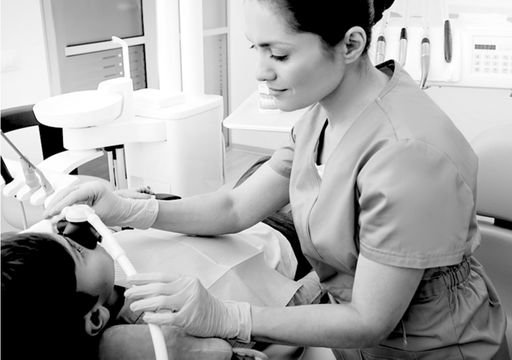 A patient wearing a mask being sedated at the dentist.