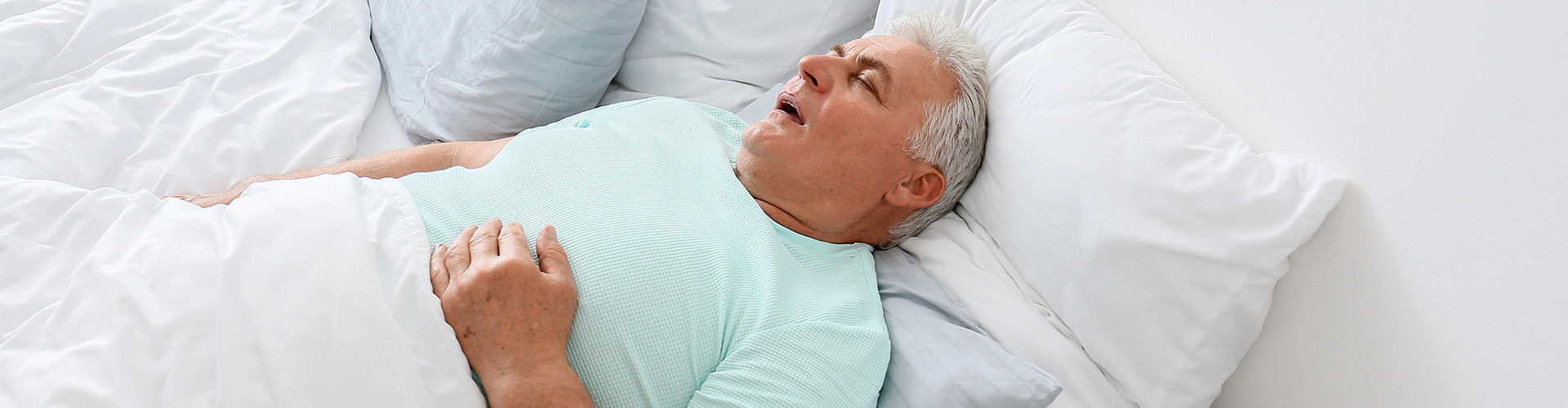 man sleeping on his back with his hand on his stomach