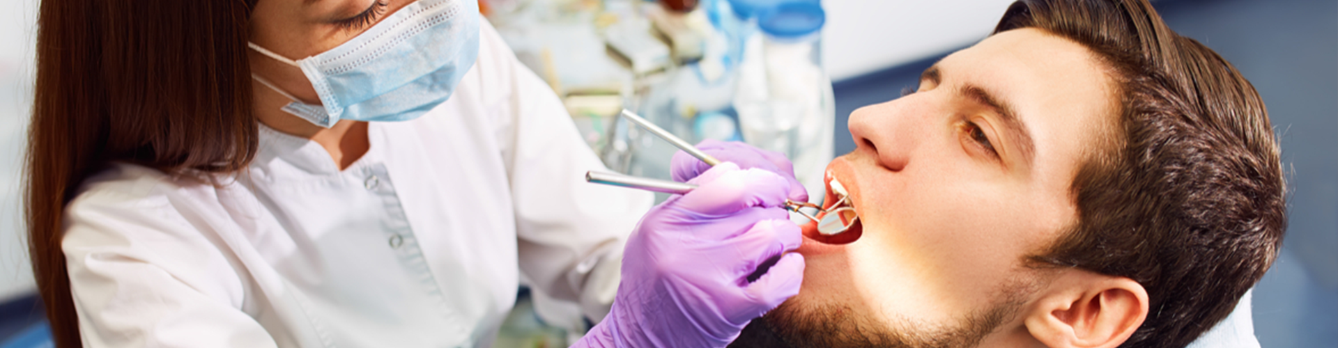 dentist checking patients mouth