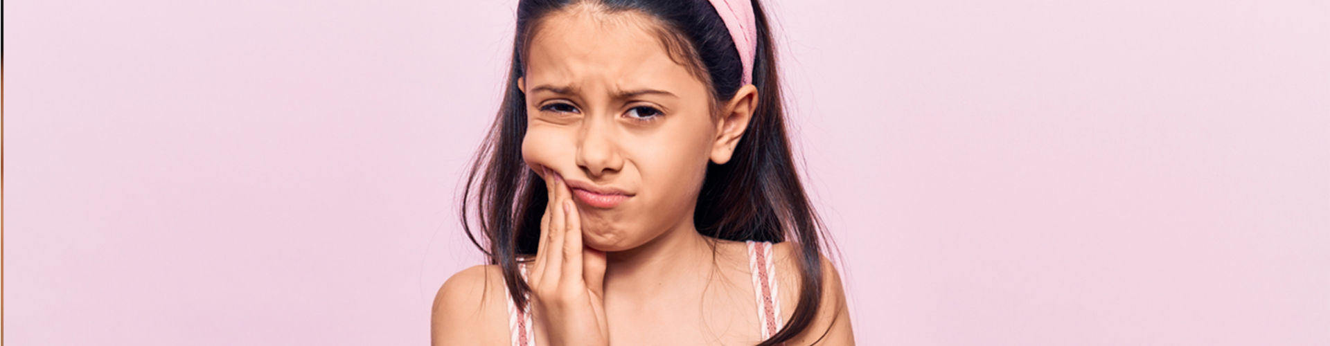 girl holding the side of her face