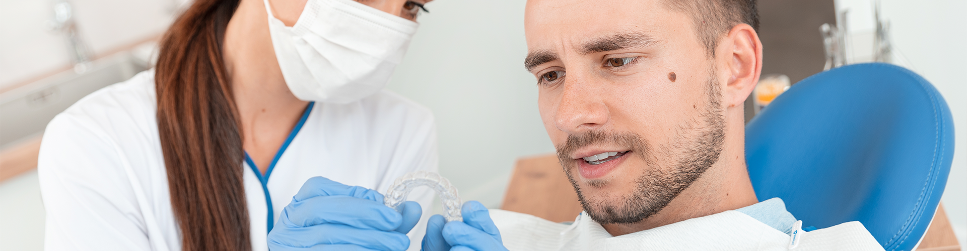 dentist showing patient clear aligner