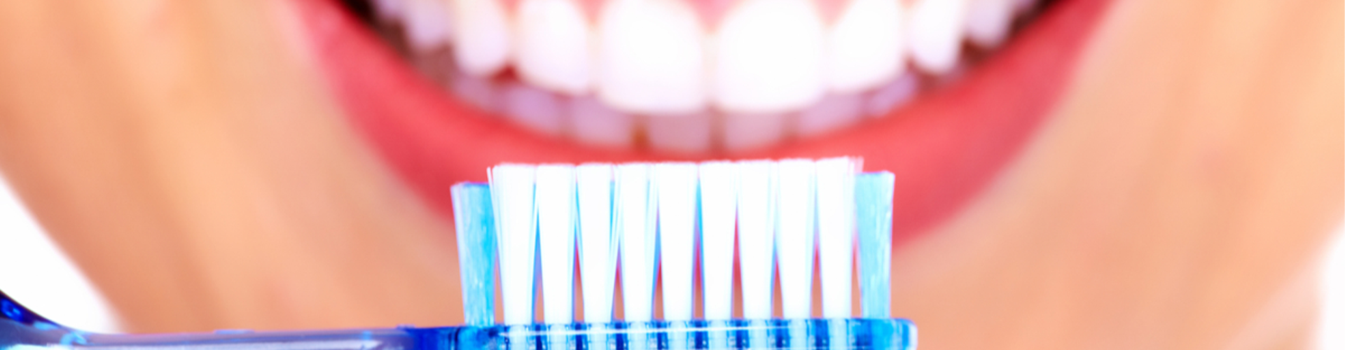 smile with toothbrush held up to it