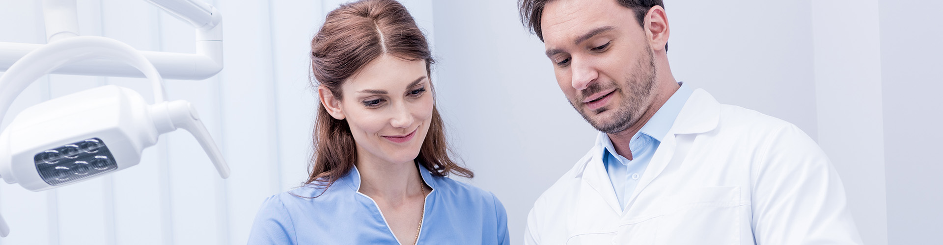 two dental professionsals reviewing a patient chart