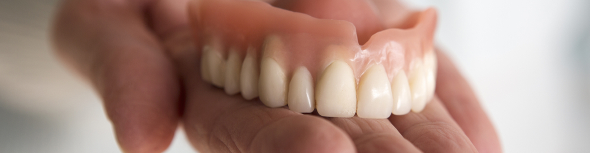 hand holding upper denture
