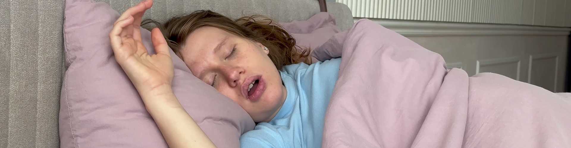 woman sleeping in bed with mouth open