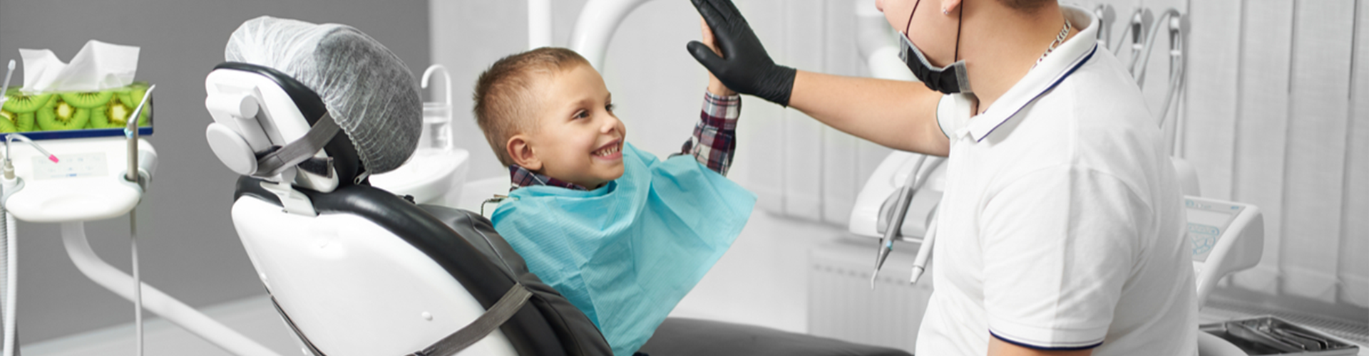 kid giving high five to dentist